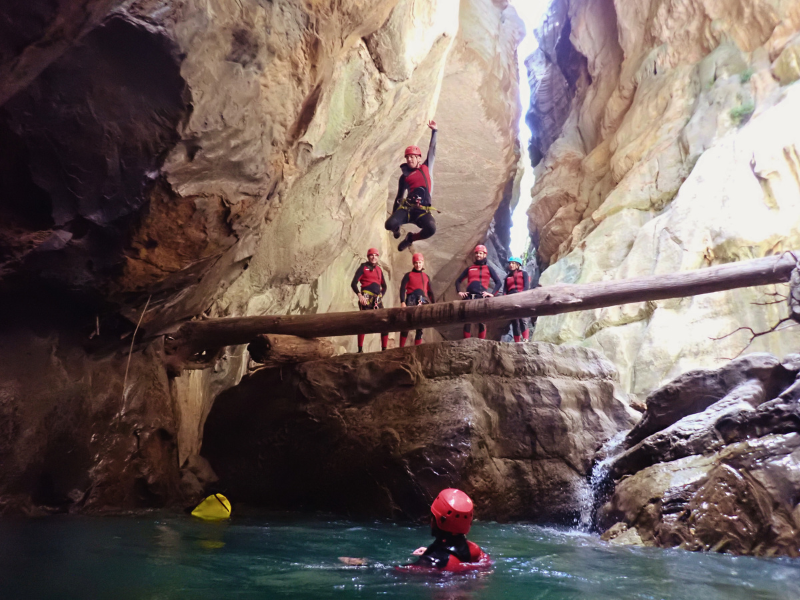 Jumping into the river water inside the winding rock formations of the Buitreras Canyon, also known as the Cathedral.