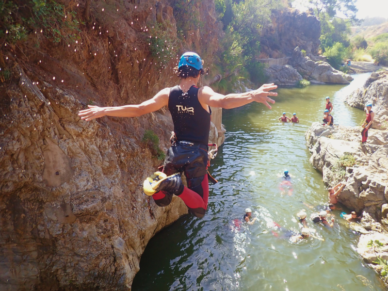 Man jumping into river from 6 metre high rock